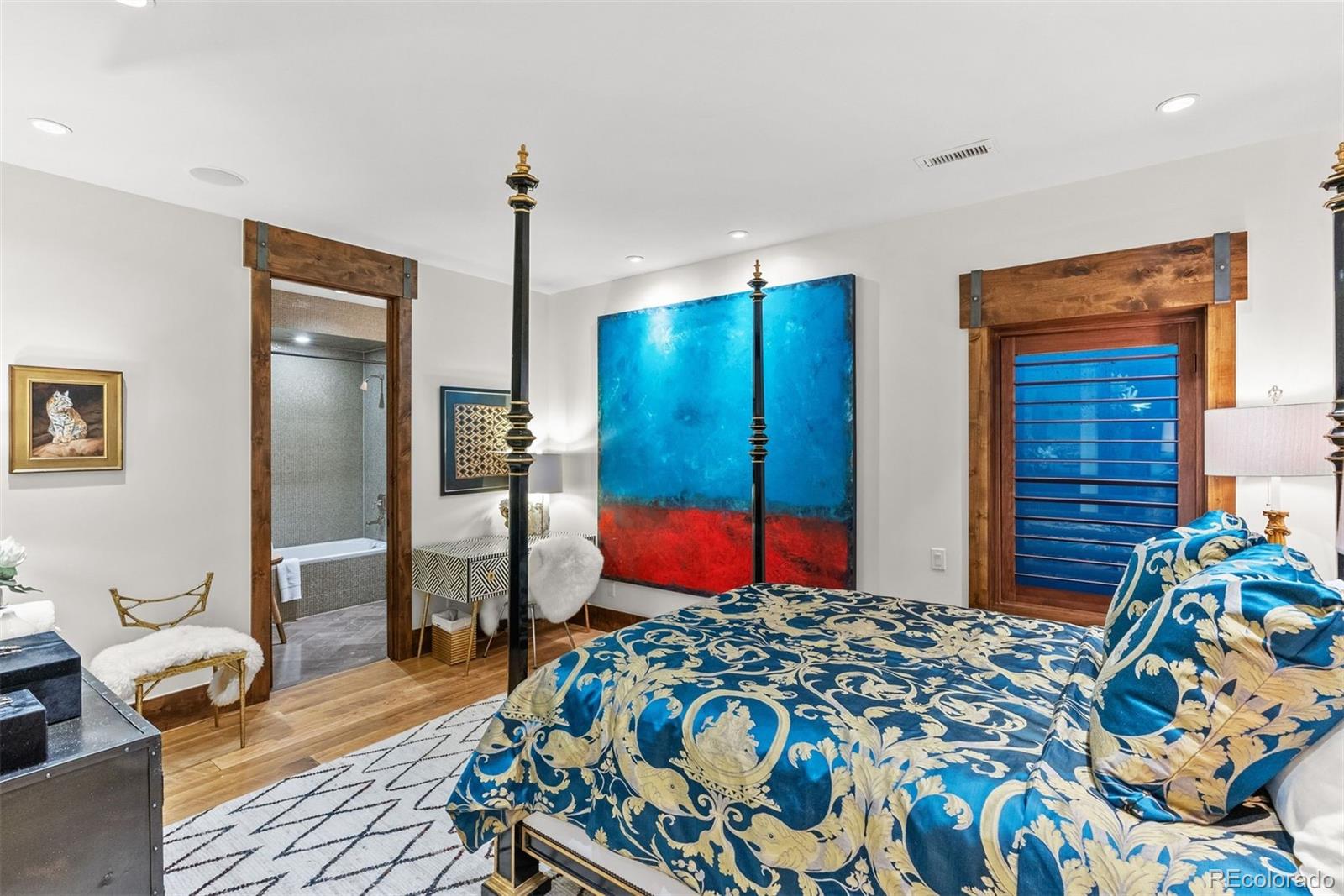 34650 Sleeping Fox Trail Evergreen, CO 80439 - Photo 32 of 49 a bedroom with bed and a chandelier