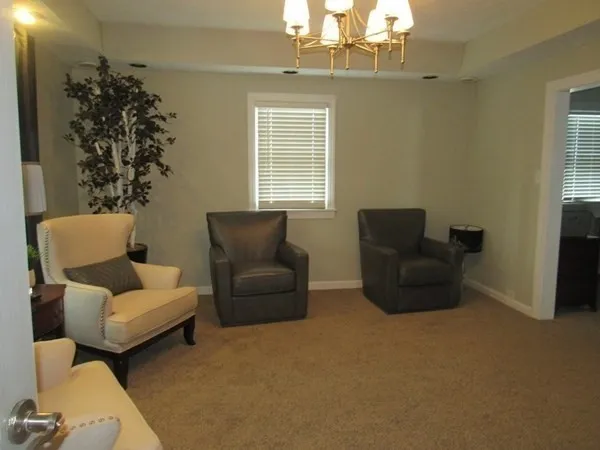 a living room with furniture and a chandelier