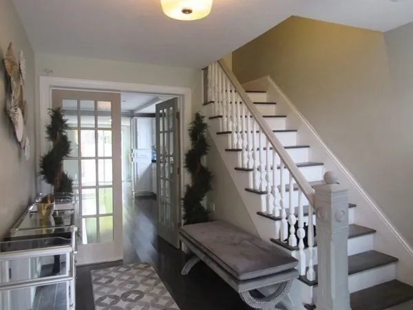 a view of entryway and hall with wooden floor