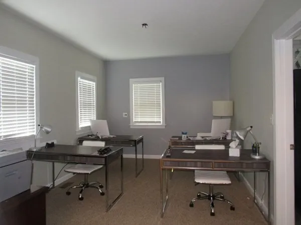 a view of a workspace with a window and lounge chair