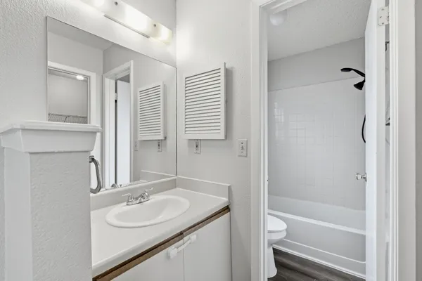 a bathroom with a sink toilet tub and shower