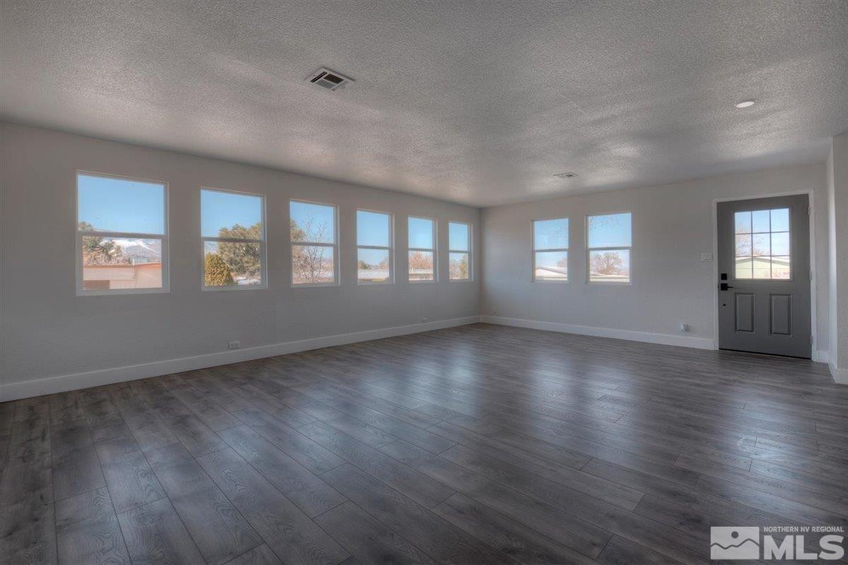 110 Gemini Circle Reno, NV 89521 - Photo 4 of 31 a view of an empty room with wooden floor and a window