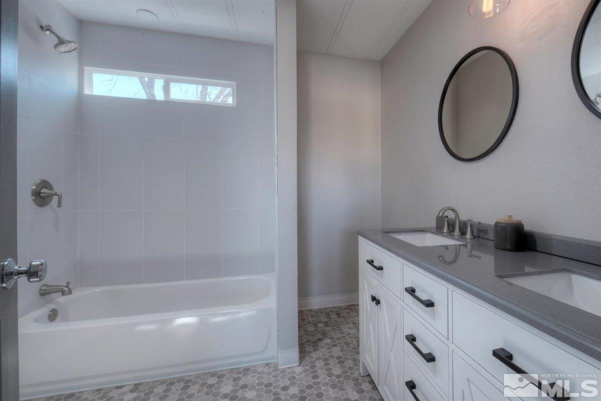 110 Gemini Circle Reno, NV 89521 - Photo 8 of 31 a bathroom with a granite countertop sink and a mirror