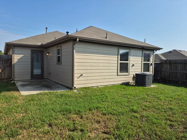 a view of a backyard with plants and a patio