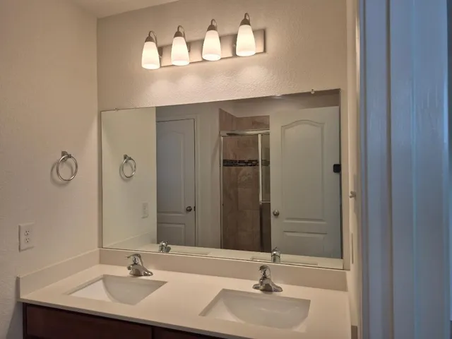 a bathroom with a glass shower door