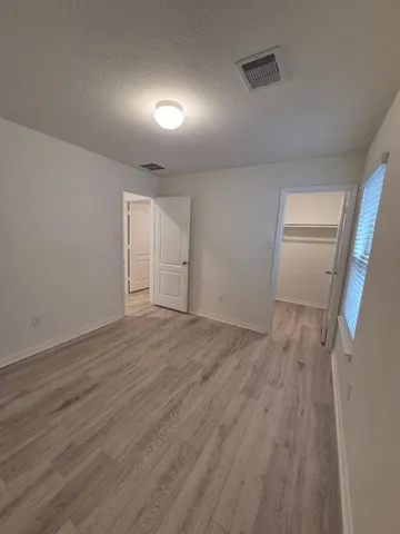 a bathroom with a bathtub sink vanity and mirror