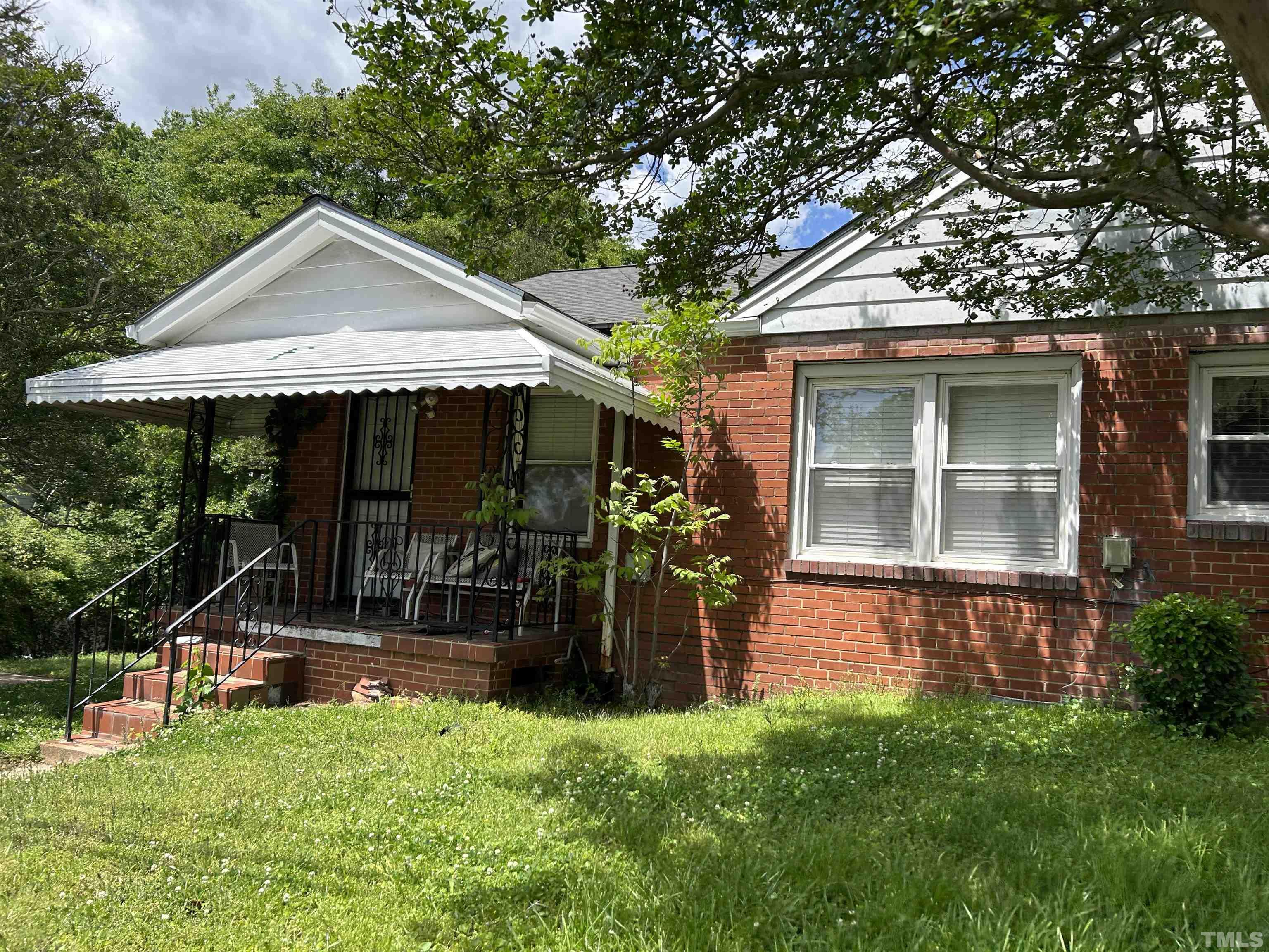 512 Coleman Street Raleigh, NC 27601 - Photo 1 of 3 a front view of a house with garden
