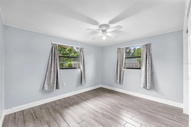 wooden floor in an empty room with a window