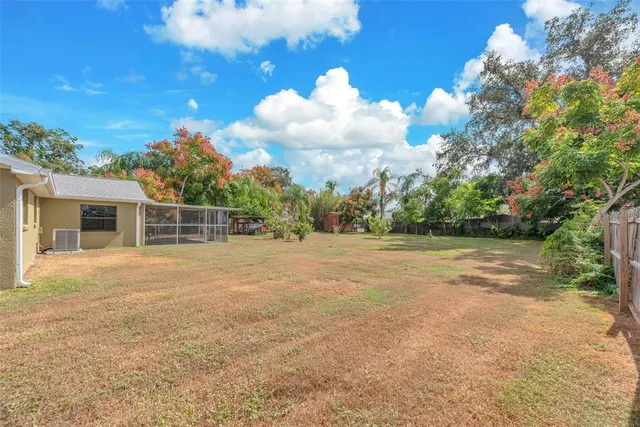 a view of a house with backyard and a garden