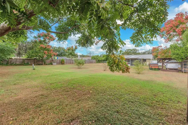 a view of yard with swimming pool and green space