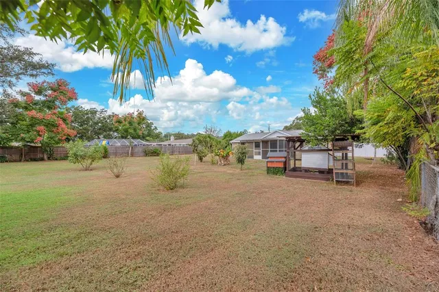 a row of palm trees and a fire pit in the middle of a yard