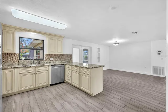 a kitchen with stainless steel appliances granite countertop a stove and a sink