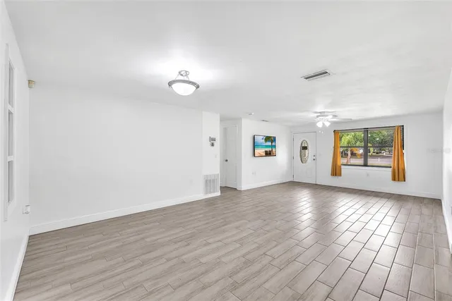 an empty room with window and windows