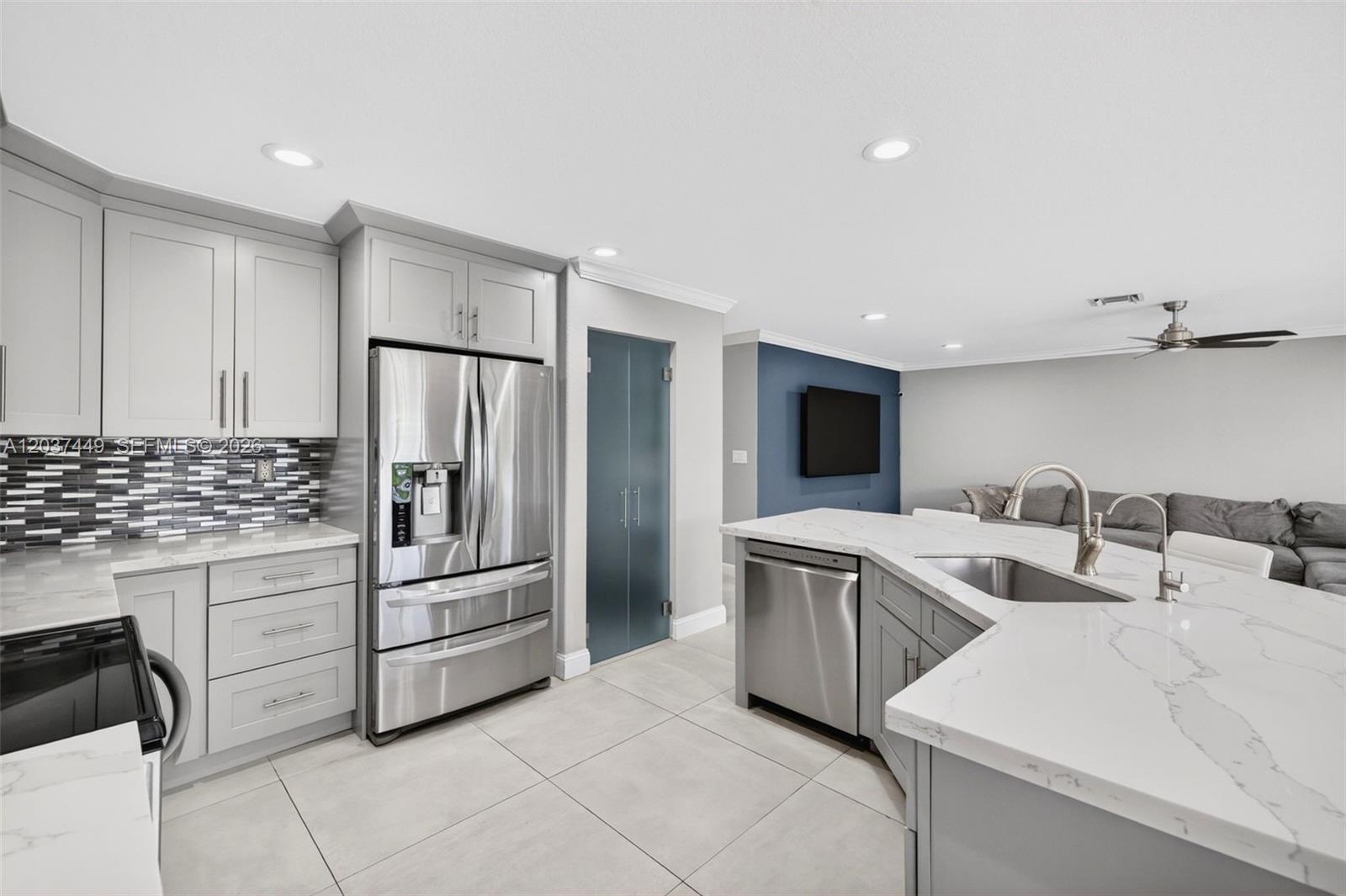 17488 Southwest 28th Court Miramar, FL 33029 - Photo 18 of 50 a kitchen with white cabinets and stainless steel appliances
