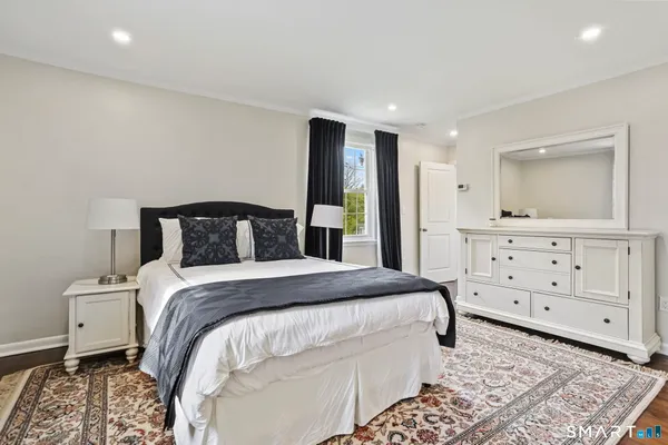 a bedroom with a bed and a dresser
