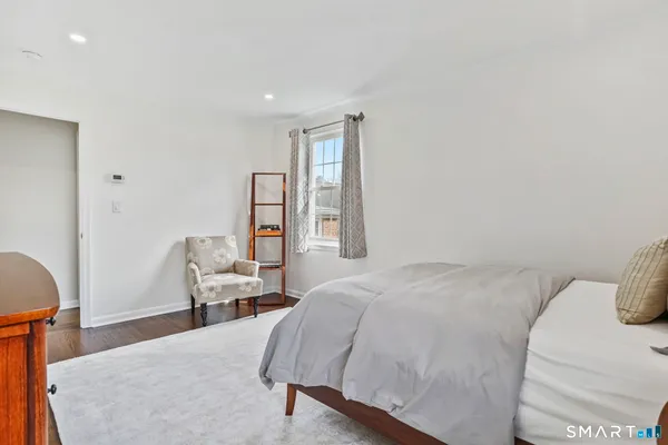 a bedroom with a bed and chair
