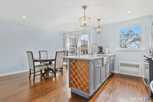 a view of a dining room with furniture wooden floor and chandelier