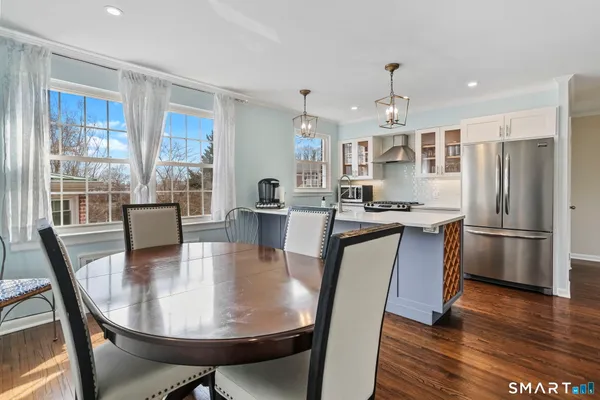 a view of a dining room with furniture window and wooden floor