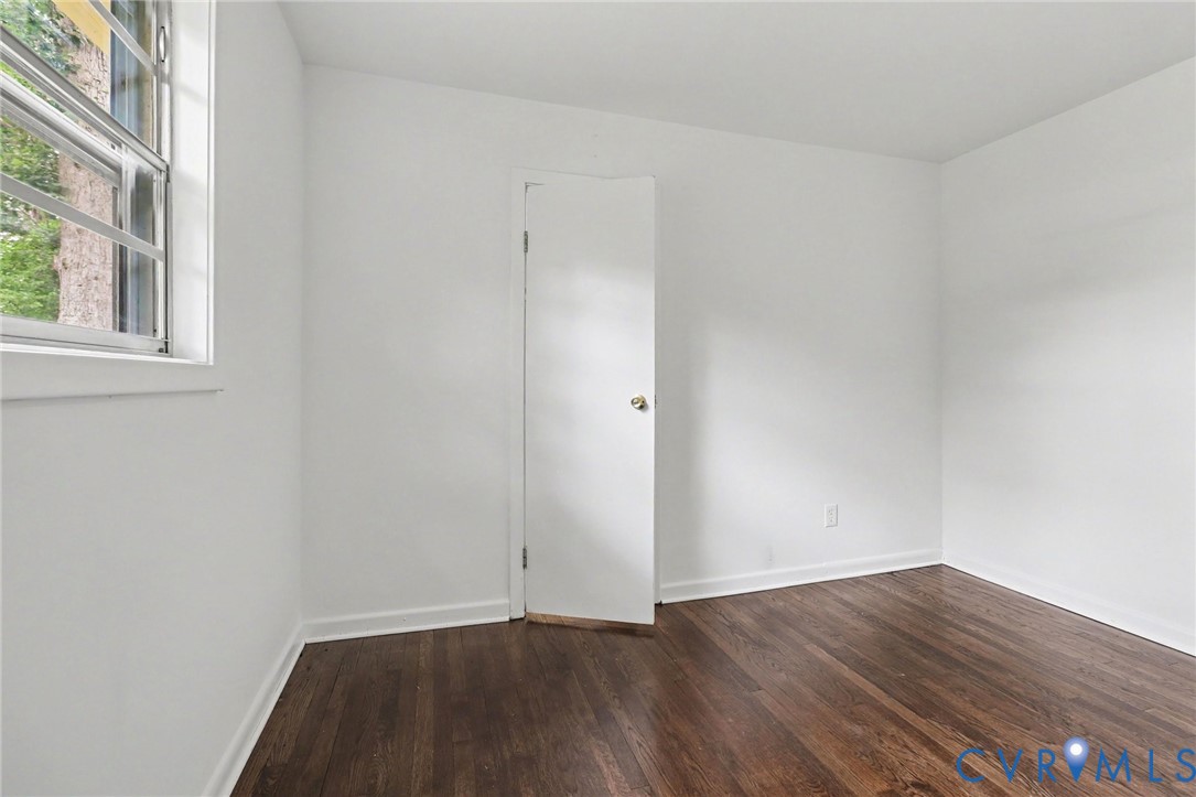 7213 Bennington Road Richmond, VA 23225 - Photo 12 of 24 Wood-finish flooring, white walls, and a casement
