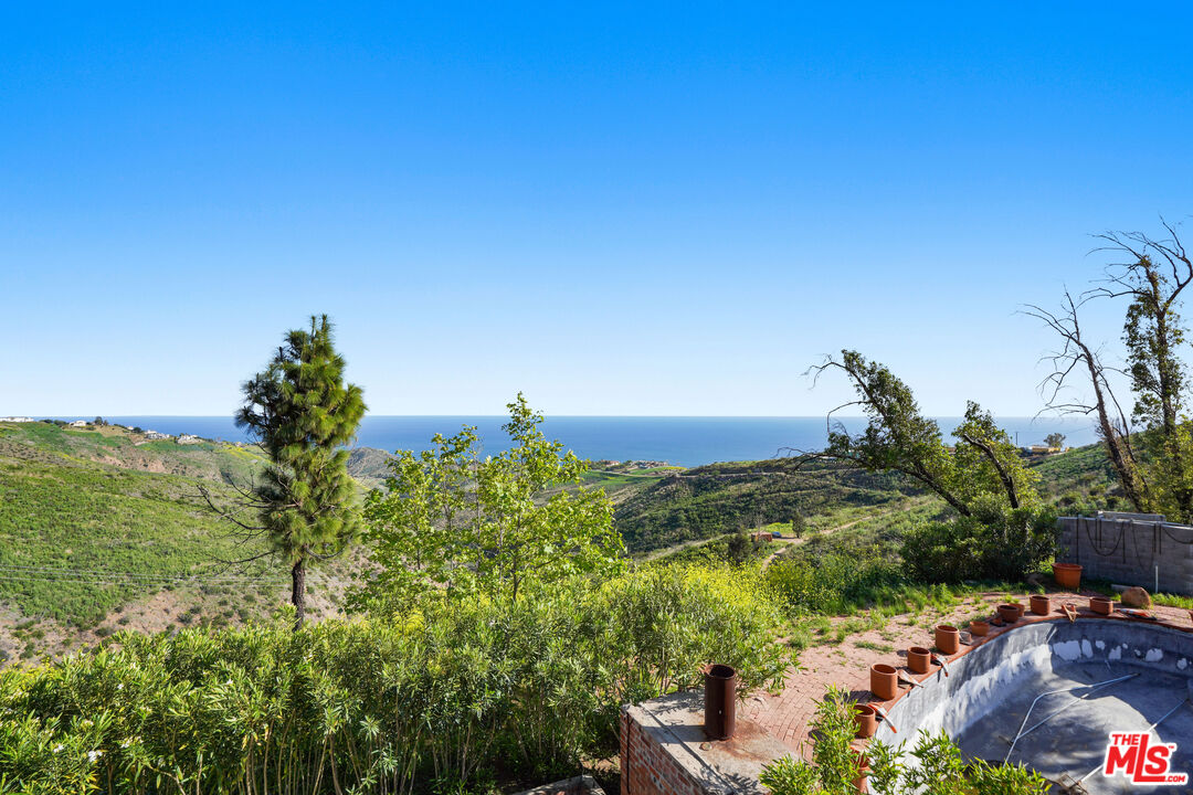 5524 Murphy Way Malibu, CA 90265 - Photo 4 of 14 a view of a lake with a building in front of it