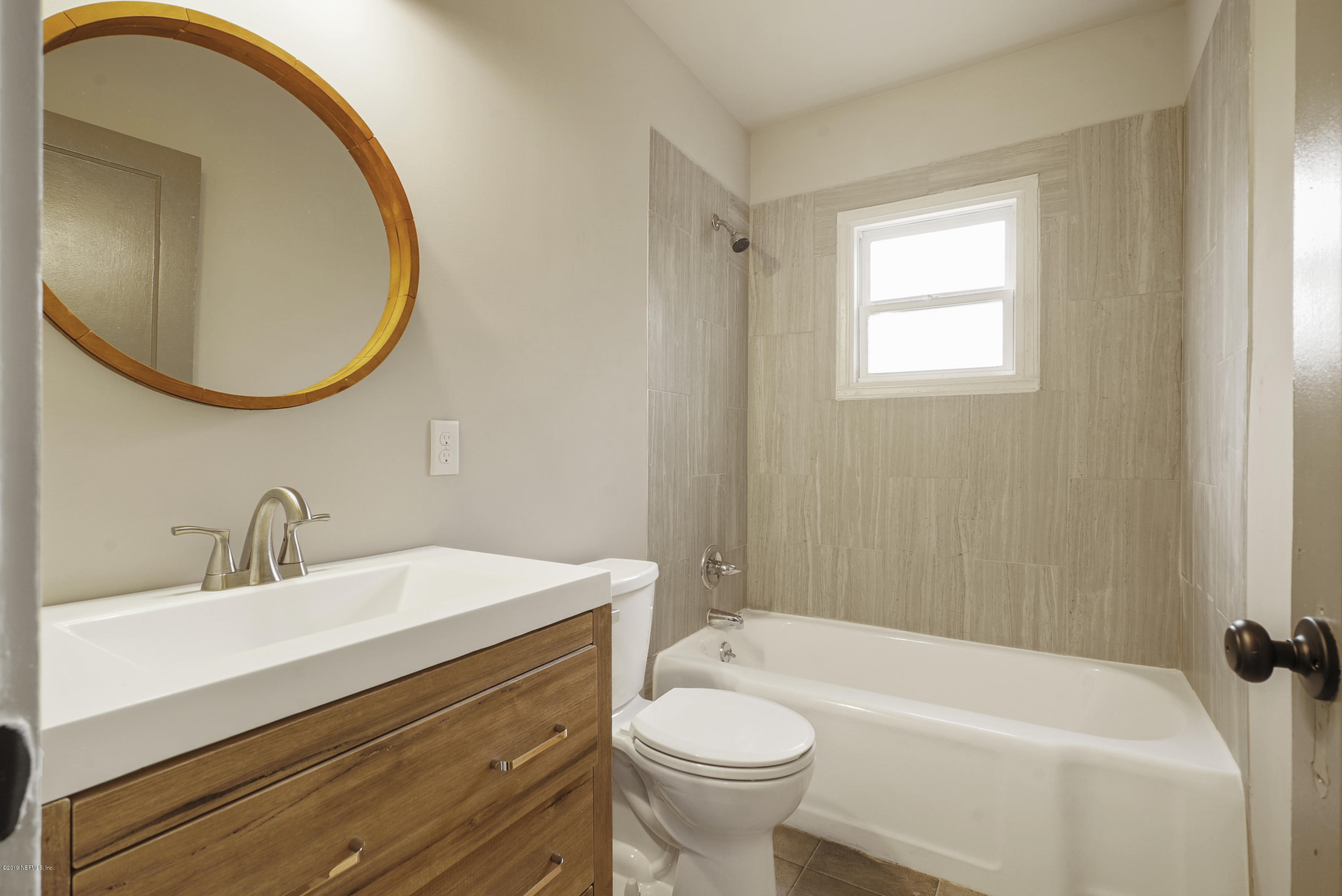 1814 Mayfair Road Jacksonville, FL 32207 - Photo 12 of 18 a bathroom with a sink a toilet and a mirror