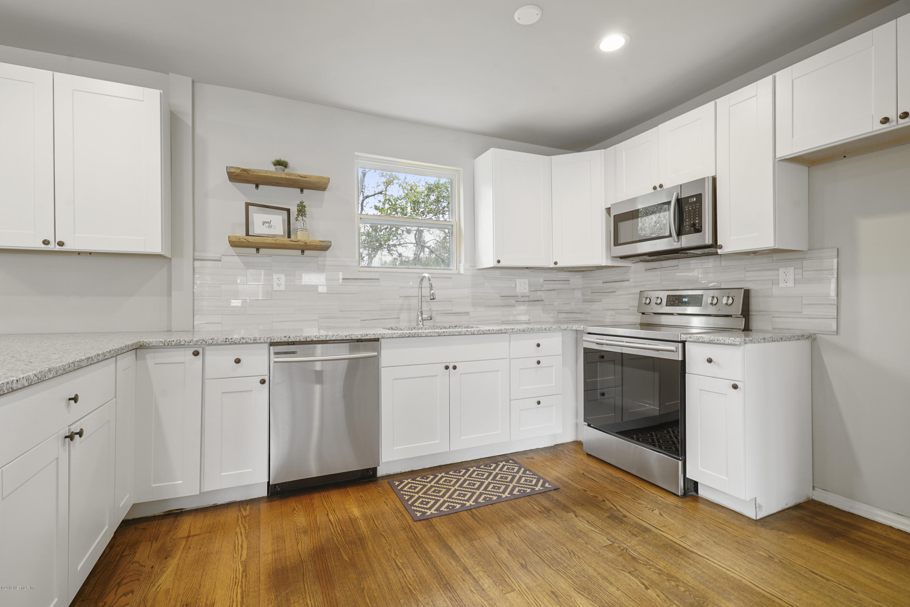 1814 Mayfair Road Jacksonville, FL 32207 - Photo 5 of 18 a kitchen with stainless steel appliances granite countertop a stove a sink and white cabinets