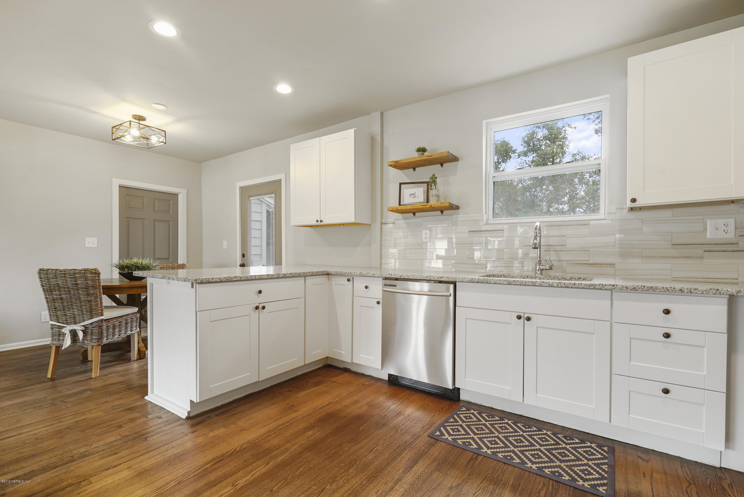 1814 Mayfair Road Jacksonville, FL 32207 - Photo 6 of 18 a kitchen with granite countertop white cabinets and white appliances