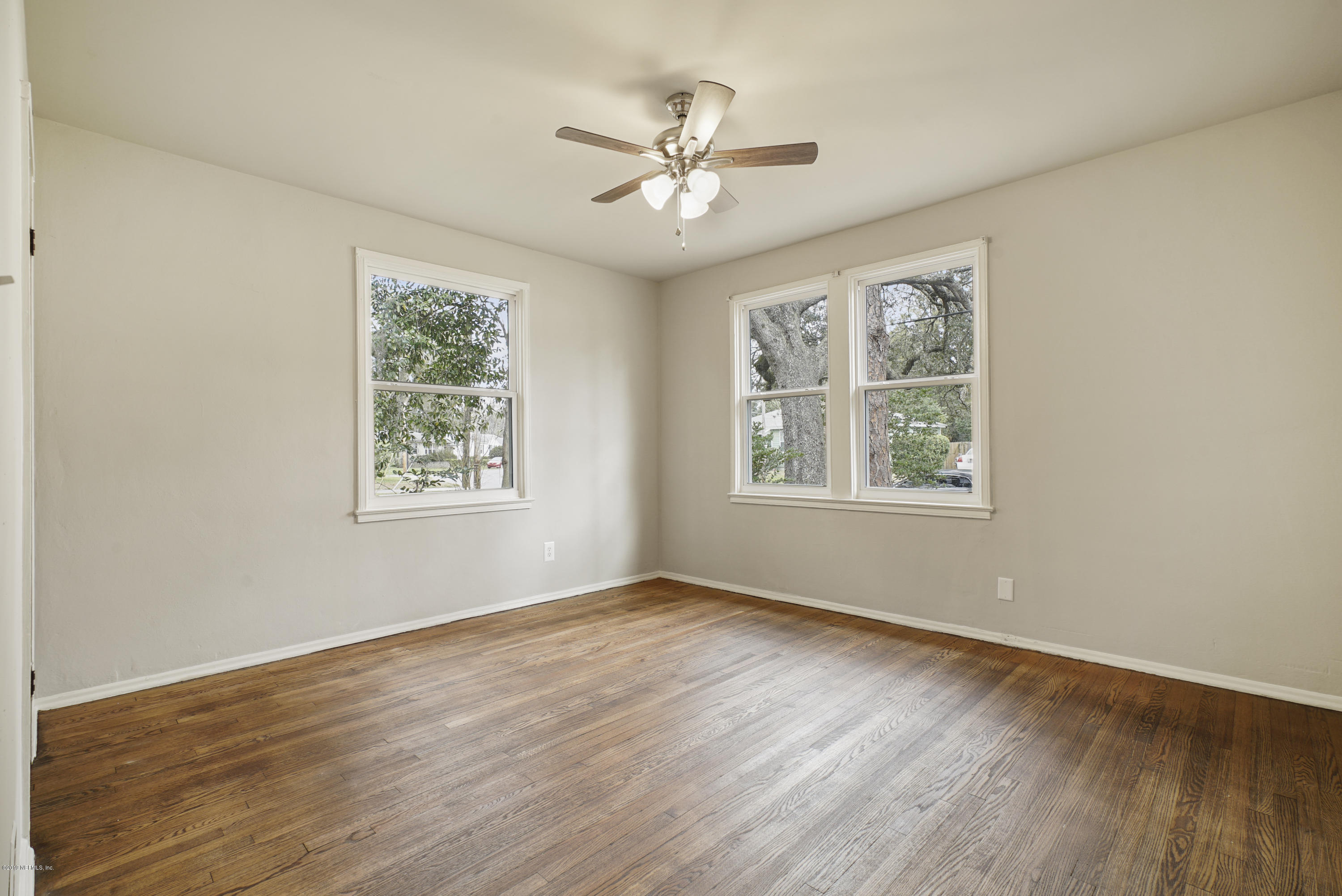 1814 Mayfair Road Jacksonville, FL 32207 - Photo 8 of 18 a view of an empty room with wooden floor and a window