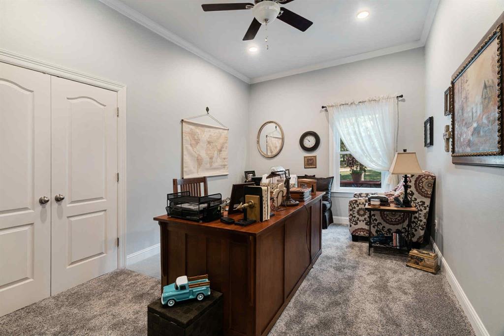 2205 County Road Blossom, TX 75416 - Photo 20 of 27 Bedroom featuring dark colored carpet, ornamental molding, and a ceiling fan