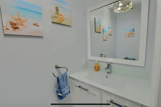 a bathroom with a sink and mirror