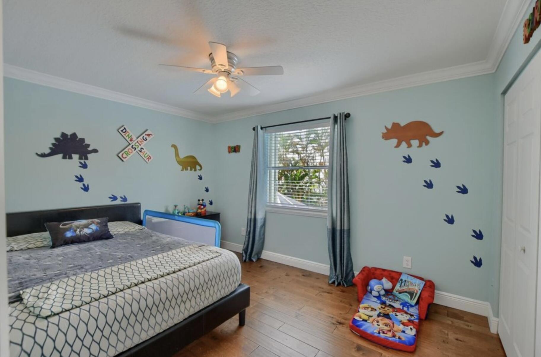 9460 Lake Serena Drive Boca Raton, FL 33496 - Photo 13 of 21 a bedroom with a bed and a chandelier