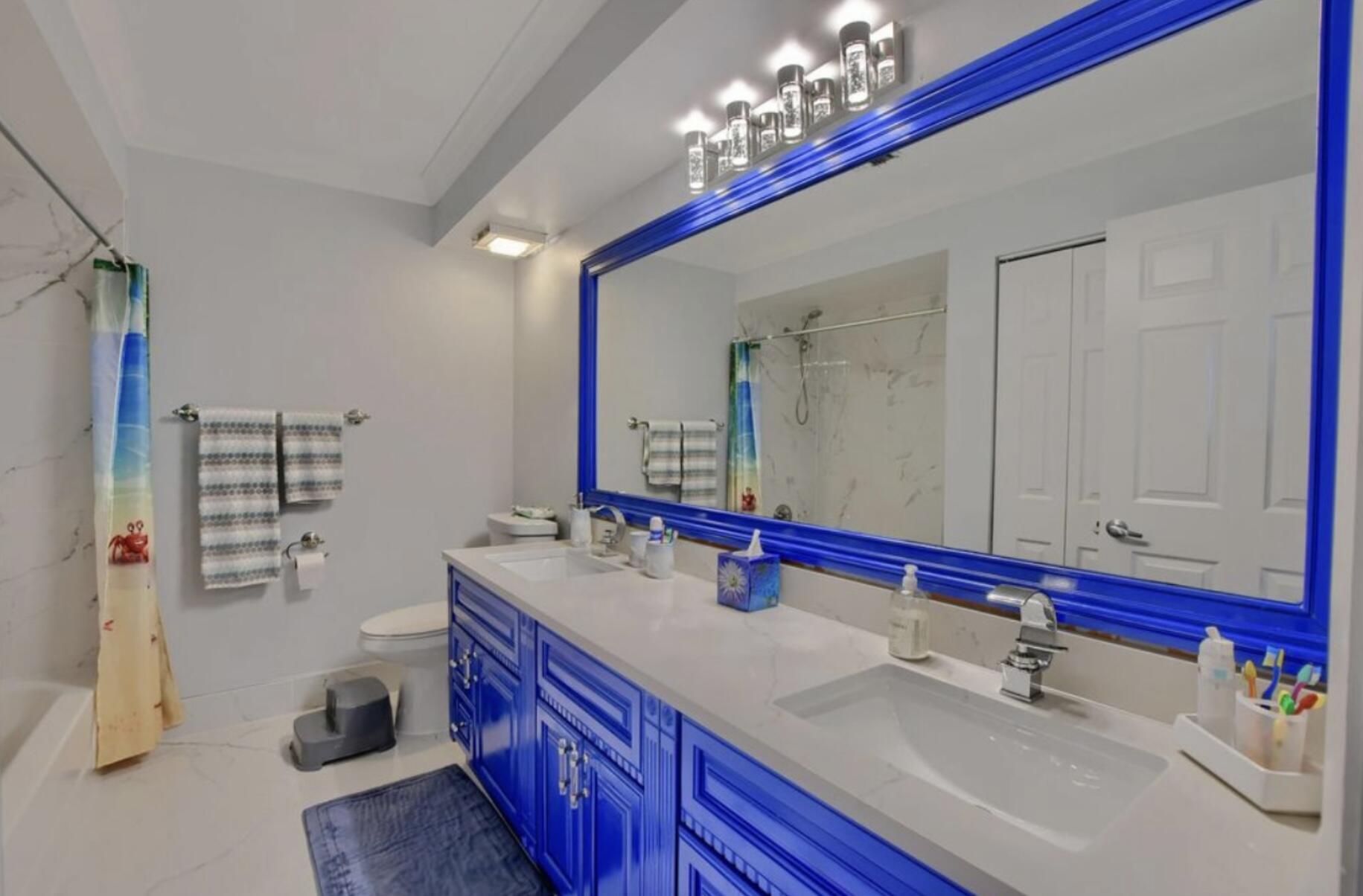 9460 Lake Serena Drive Boca Raton, FL 33496 - Photo 15 of 21 a bathroom with a double vanity sink and a mirror