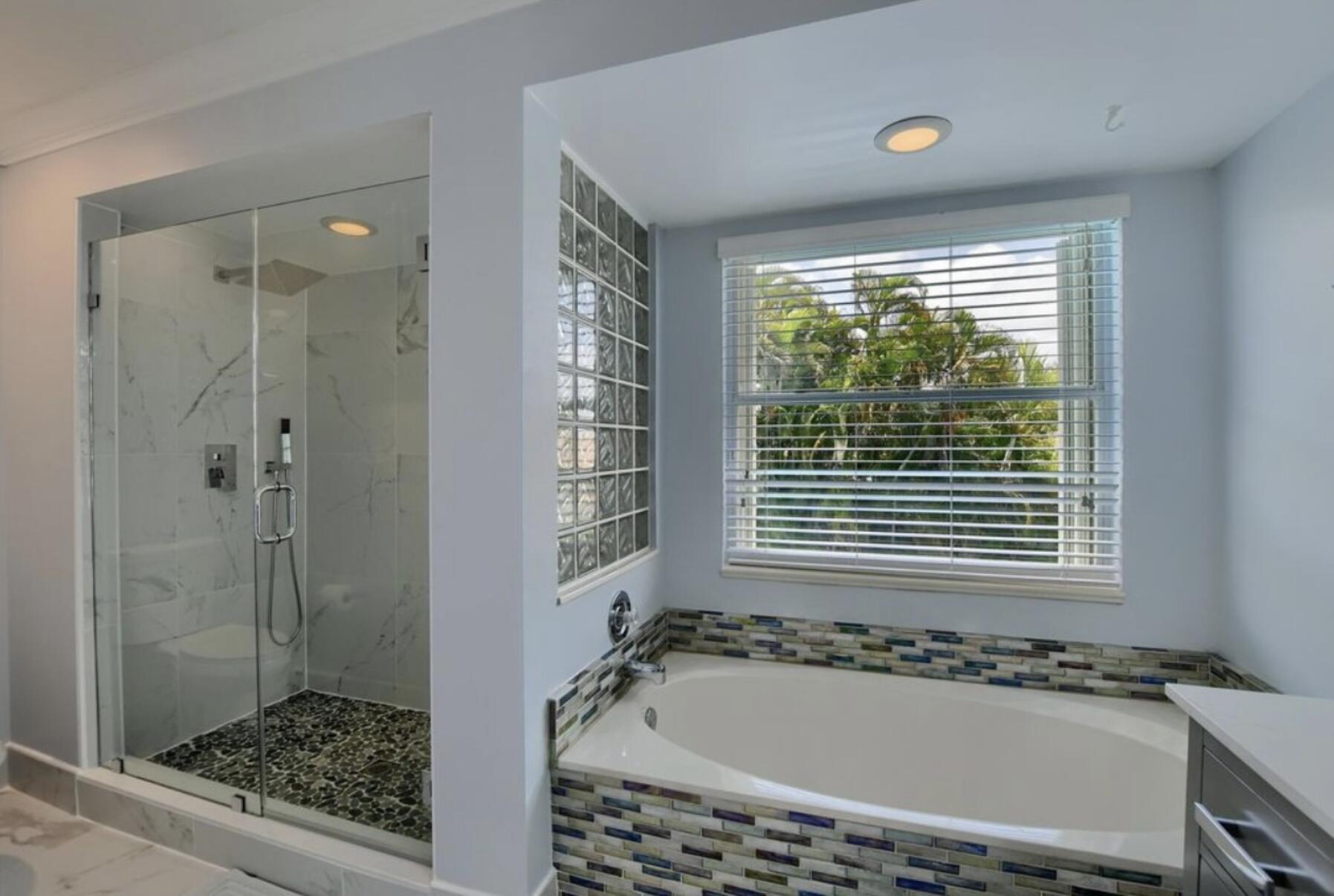 9460 Lake Serena Drive Boca Raton, FL 33496 - Photo 19 of 21 a bathroom with a bathtub and a shower
