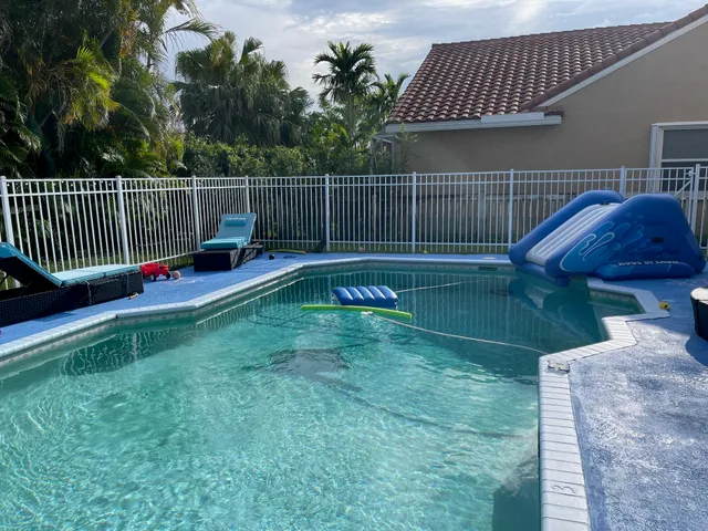 a view of backyard with trampoline
