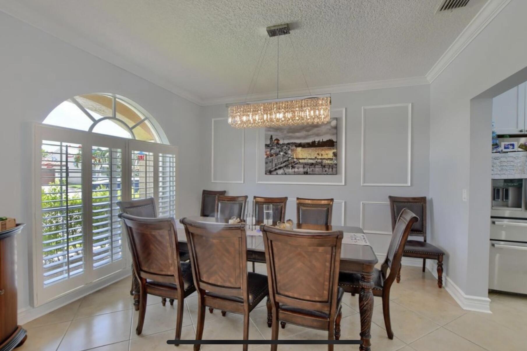 9460 Lake Serena Drive Boca Raton, FL 33496 - Photo 6 of 21 a view of a dining room with furniture window and wooden floor