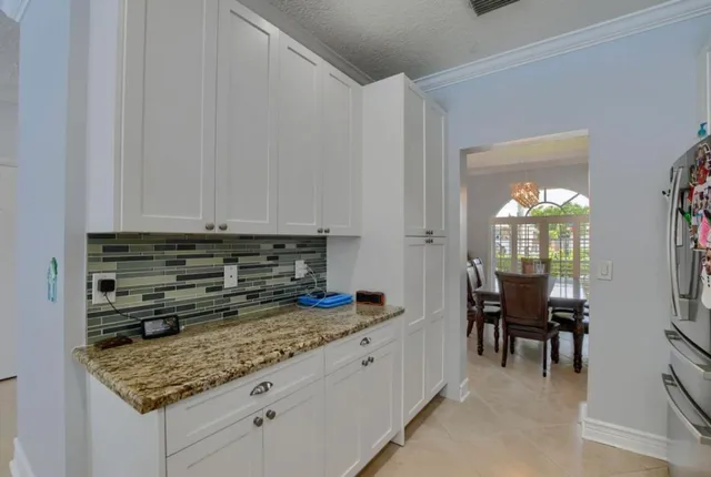 a kitchen with granite countertop a sink and cabinets