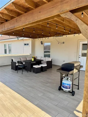 a view of a patio with table and chairs with wooden floor