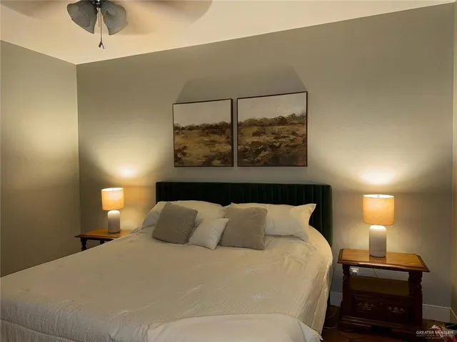 a bedroom with a bed and a lamp