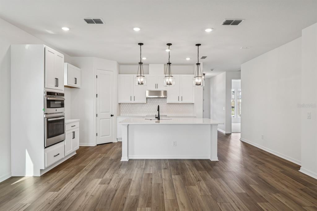 6644 Wake Street St. Cloud, FL 34771 - Photo 11 of 48 a large white kitchen with stainless steel appliances