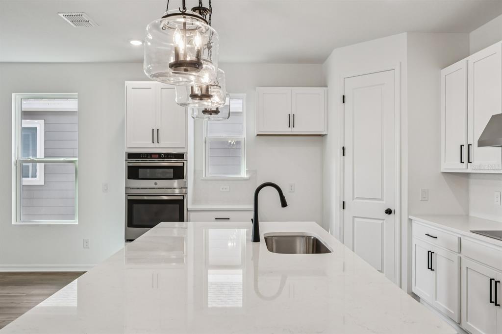 6644 Wake Street St. Cloud, FL 34771 - Photo 15 of 48 a kitchen with stainless steel appliances kitchen island a refrigerator sink and cabinets