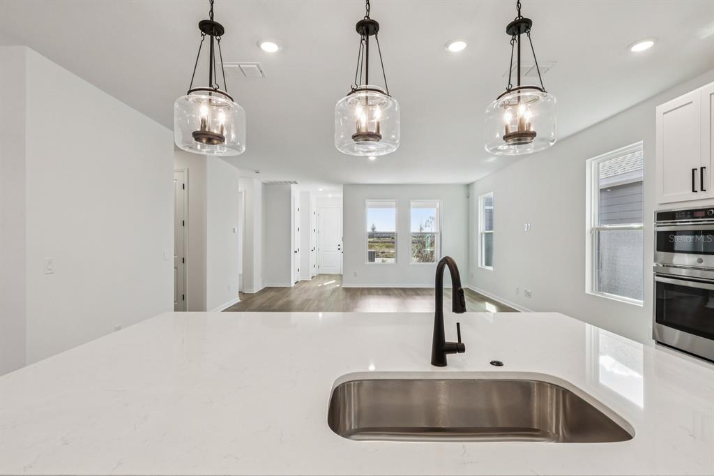 6644 Wake Street St. Cloud, FL 34771 - Photo 17 of 48 a kitchen with a chandelier stainless steel appliances and chandelier