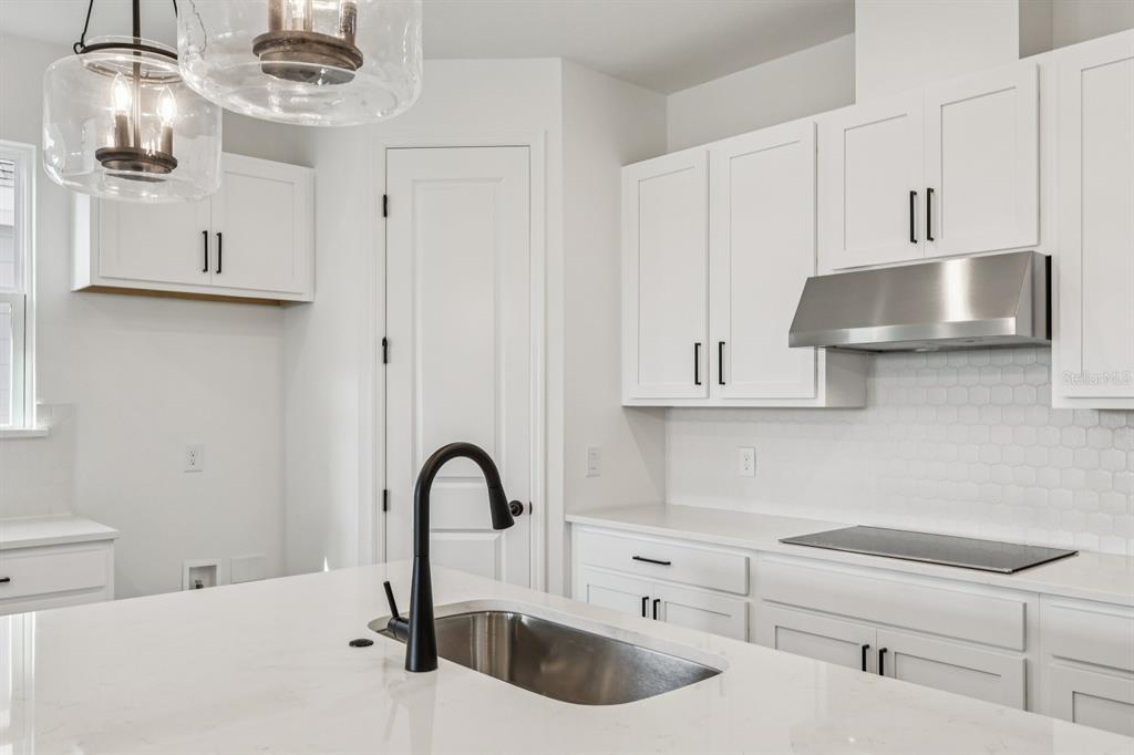 6644 Wake Street St. Cloud, FL 34771 - Photo 18 of 48 a kitchen with white cabinets a sink and dishwasher