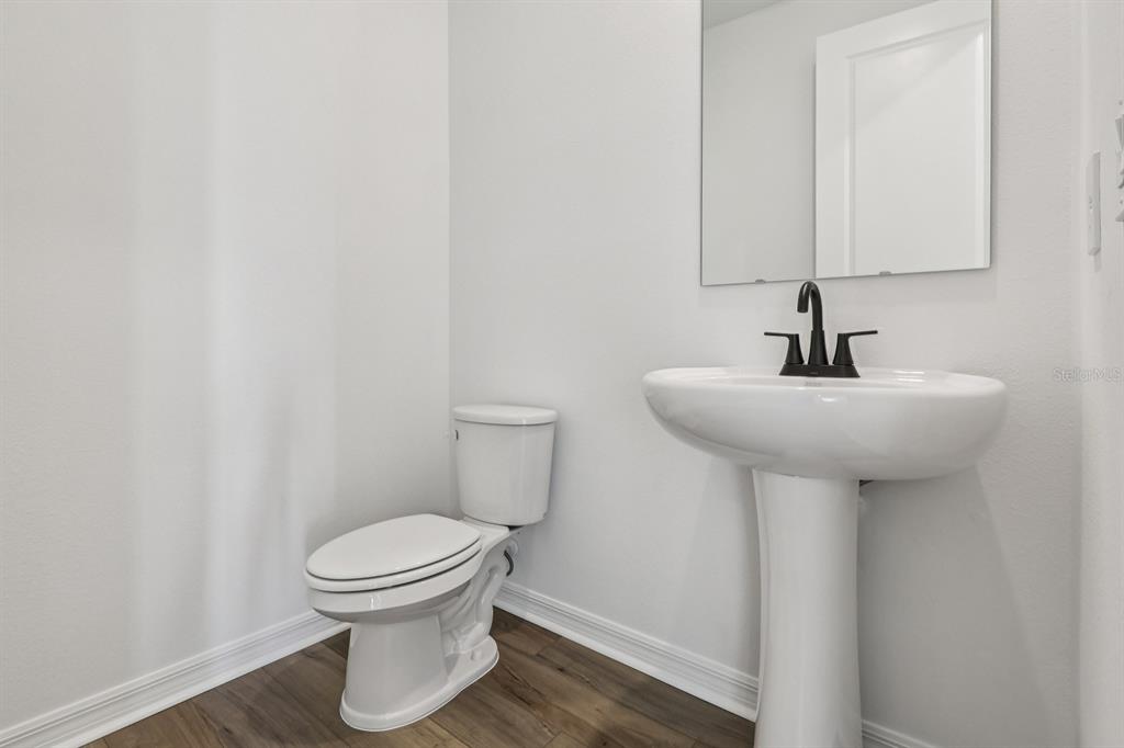 6644 Wake Street St. Cloud, FL 34771 - Photo 26 of 48 a bathroom with a sink toilet and a mirror