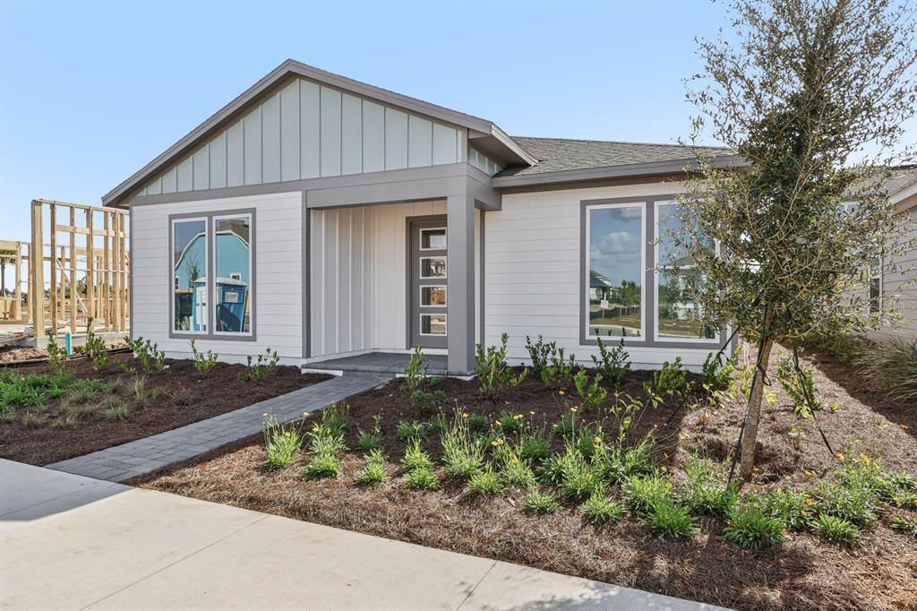 6644 Wake Street St. Cloud, FL 34771 - Photo 3 of 48 a front view of a house with garden
