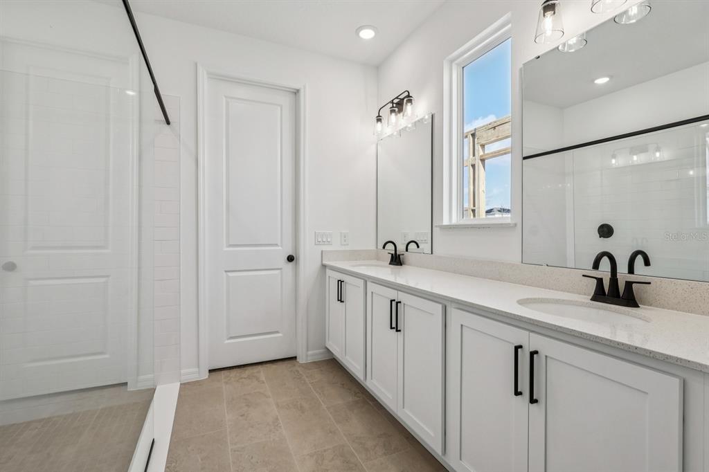 6644 Wake Street St. Cloud, FL 34771 - Photo 32 of 48 a bathroom with double vanity sink and a mirror