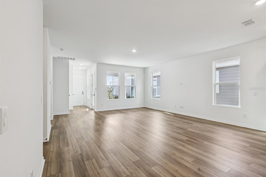 6644 Wake Street St. Cloud, FL 34771 - Photo 6 of 48 an empty room with wooden floor and windows