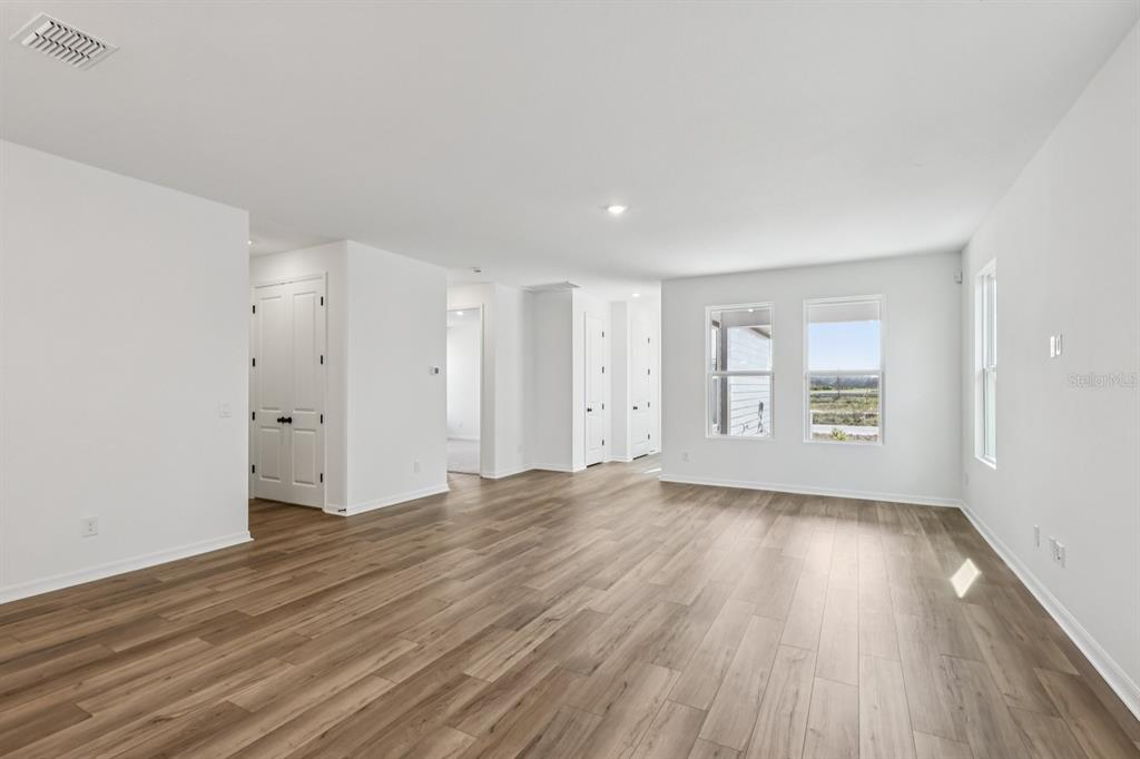 6644 Wake Street St. Cloud, FL 34771 - Photo 7 of 48 a view of an empty room with wooden floor and a window