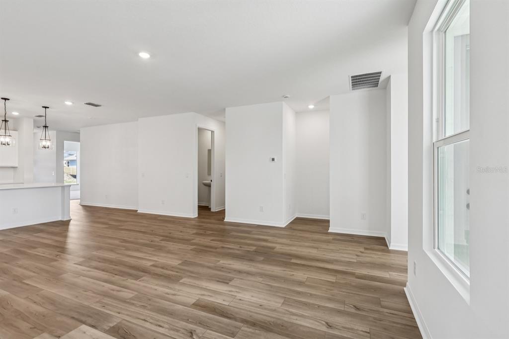 6644 Wake Street St. Cloud, FL 34771 - Photo 8 of 48 a view of an empty room with wooden floor and a window