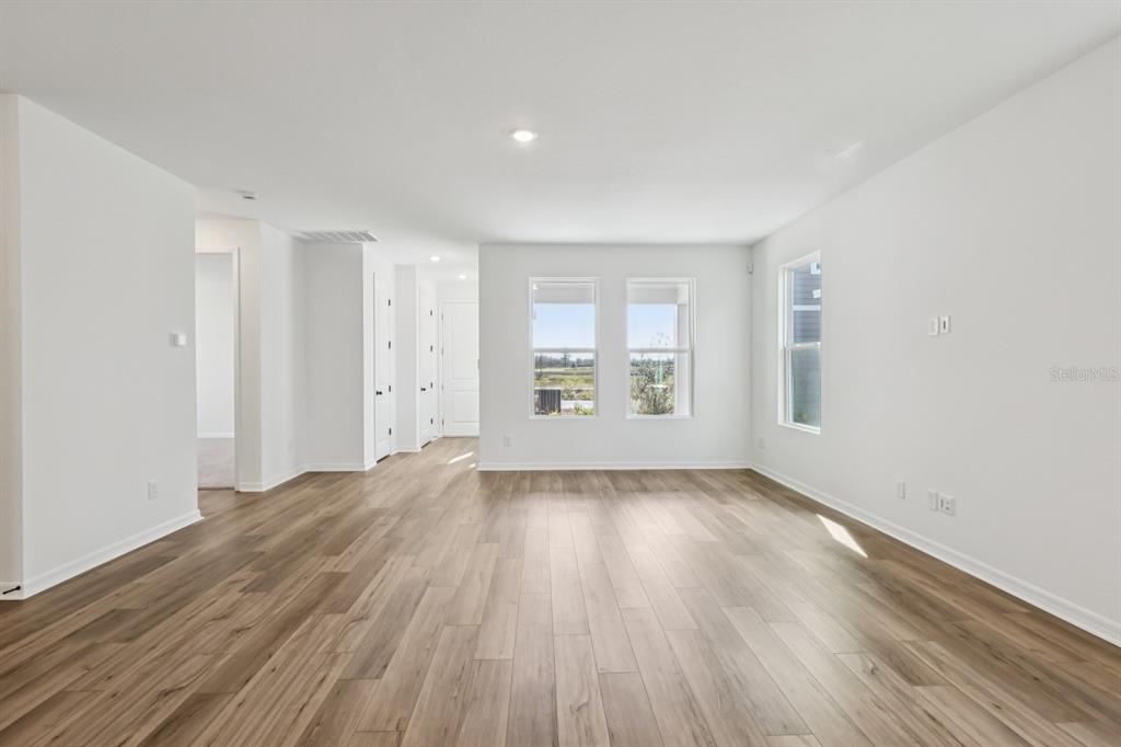 6644 Wake Street St. Cloud, FL 34771 - Photo 10 of 48 an empty room with wooden floor and window