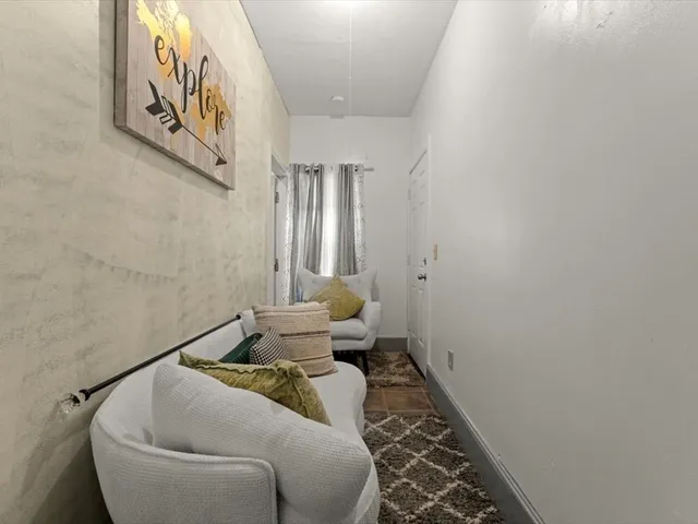 a living room with furniture and a rug